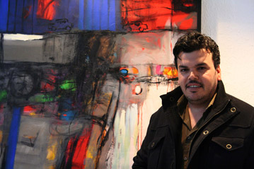 Wadhah Mahdi, an Iraqi refugee artist in Damascus, with one of his paintings which will be featured in the exhibit along with paintings from some 19 other Iraqi refugee artists. Photo: UNHCR/G.Brust 