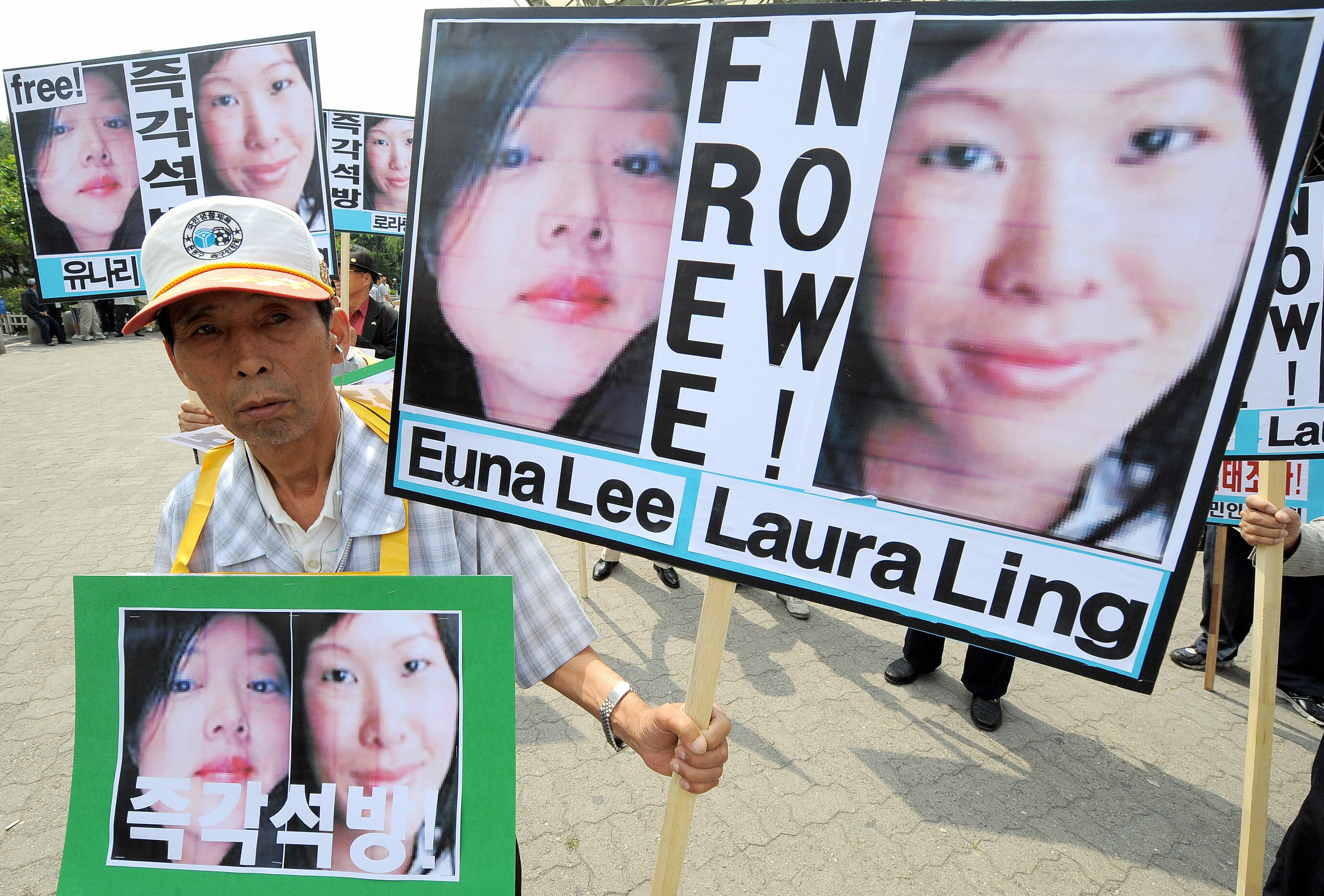 A South Korean activist holding pictures of U.S. journalists Euna Lee and Laura Ling