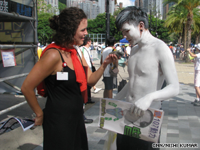 CNN's Miranda Leitsinger with Leonard So,who painted his body white to support freedom of expression.