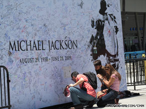 Fans sign a mural near Staples Center in Los Angeles, California Sunday.