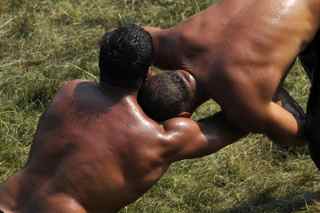 MUSTAFA OZER/AFP/Getty Images. Turkish oil wrestlers fight during the 648th historical Kirkpinar oilwrestling tournament held every year in Sarayici, near Edirne, on July 5, 2009.