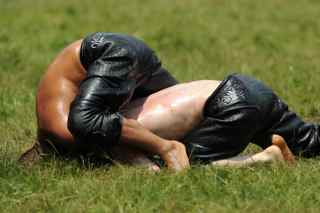MUSTAFA OZER/AFP/Getty Images. Turkish oil wrestlers fight during the 648th historical Kirkpinar oilwrestling tournament held every year in Sarayici, near Edirne, on July 5, 2009.