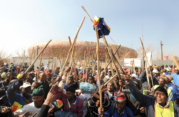 Workers strike in front of the unfinished Soccer City stadium in Soweto.