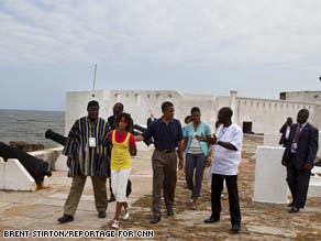 The Obama family walks around the Cape Coast Castle in Ghana.