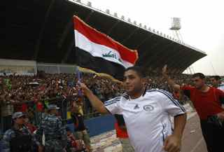 AHMAD AL-RUBAYE/AFP/Getty Images. The Iraqi team is welcomed by fans onto the pitch at the start of the friendly match Iraq versus Palestine at the al-Shaab Stadium in central Baghdad on July 13, 2009. Iraq won 4-0. Over 50,000 fans attended the first international football match played in the Iraqi capital since the US-led invasion of the country in 2003.
