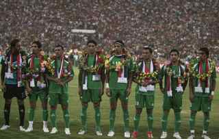 AHMAD AL-RUBAYE/AFP/Getty Images. Members of the Iraqi team line up at the start of their friendly match Iraq versus Palestine at the al-Shaab Stadium in central Baghdad on July 13, 2009. Iraq won 4-0.