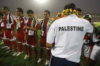 AHMAD AL-RUBAYE/AFP/Getty Images. Members of the Palestinian team stand on the pitch at the start of the friendly match Iraq versus Palestine at the al-Shaab Stadium in central Baghdad on July 13, 2009. Iraq won 4-0.