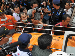 A body is removed after two hotels were bombed in Jakarta.