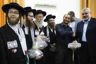 MOHAMMED ABED/AFP/Getty Images. Hamas leader Ismail Haniya (R) gives gifts to members the anti-Zionist religious Jewish communities of the USA Naturei Karta during their visit to Gaza City on July 16, 2009.
