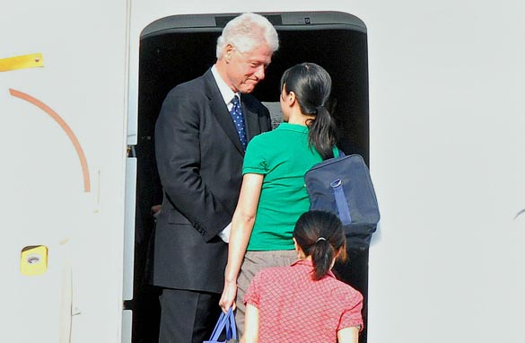 This photo released by North Korea's official Korean Central News Agency shows former President Bill Clinton greeting two US journalists Laura Ling (in green) and Euna Lee (red) after winning their release from the communist country as they leave Pyongyang airport to the US in a chartered plane on August 5, 2009. (KNS/AFP/Getty Images)