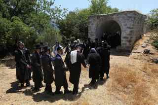 MENAHEM KAHANA/AFP/Getty Images. Thousands of ultra-Orthodox Jews are visiting the Galilee sites in northern Israel during their summer holidays.