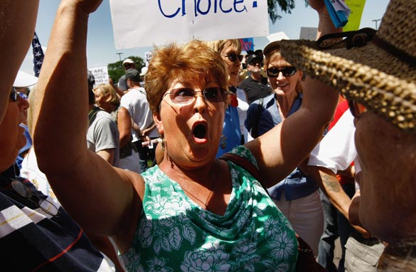 Anita Rossi argues against Democratic Party health care proposals, shouting 'It's my money' on August 8, 2009 in Brighton, Colorado. (Photo by John Moore/Getty Images)