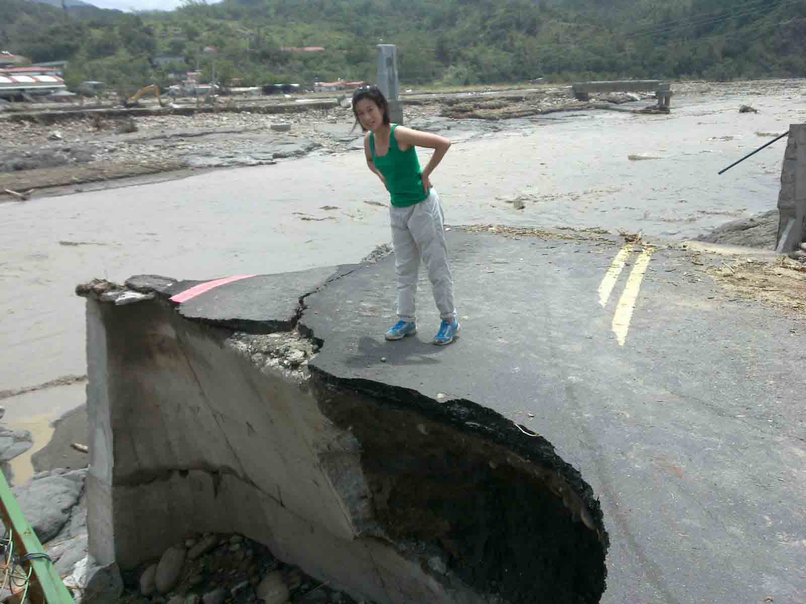 CNN’s Pauline Chiou stands on what remains of a washed out bridge in Jia Shian, Taiwan.