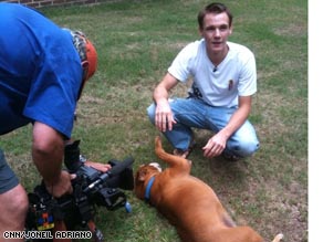 Tyler Edmonds at home in Columbus, M.S. with a dog he adopted from an animal shelter.
