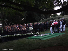 The Kennedy family gathers around the gravesite Saturday evening during the funeral for Sen. Ted Kennedy at Arlington National Cemetery.