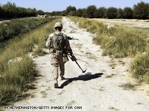 A U.S. Marine sweeps for Improvised Explosive Devices (IED's) along the pathways around their base at Camp Jaker.