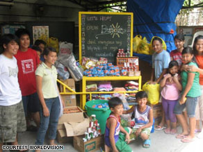 Volunteers pack up bags of donated items like clothing and blankets to distribute to children and families in need in Cavite, Philippines.