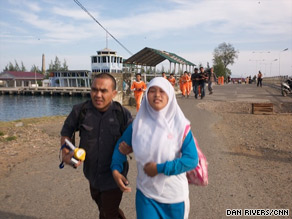 A tsunami drill is carried out in Banda Aceh, with droning alarms and people fleeing an imaginary wave.