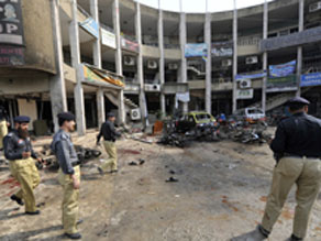 Pakistani policemen secure the site after a suicide bomb blast in Rawalpindi on Monday.