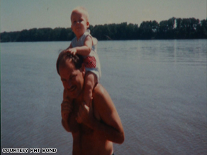 Father Henry Willenborg holding his son on a family vacation.