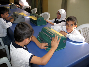 Students use brailers at Baghdad's school for the blind.