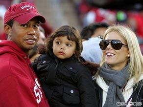 Tiger Woods holds his daughter Sam and stands next to his wife, Elin Nordegren, at a game in Palo Alto, California. 