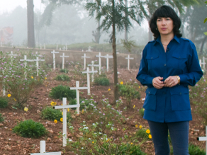 Christiane Amanpour standing in a graveyard in Rwanda for her documentary 'Scream Bloody Murder'