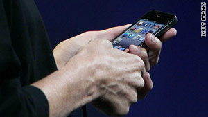 Steve Jobs shows the iPhone 4 at the WWDC conference.
