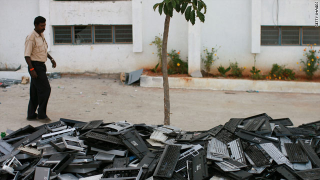 Selling, recycling or donating an old cell phone keeps it out of electronic garbage dumps like this one in Dobbspet, India.