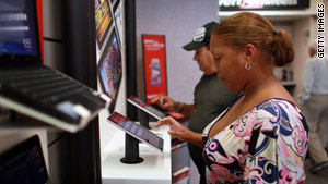 Customers check out iPads in Coral Gables, Florida. Soon they may be reading a digital newspaper on them.