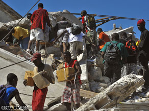 Looters search under the rubble in Port-au-Prince
