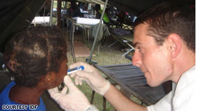 A medic at the IDF Field Hospital in Port-au-Prince checks on an injured child.