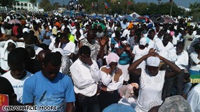 Tens of thousands of Haitians gather at the city center to remember those lost.