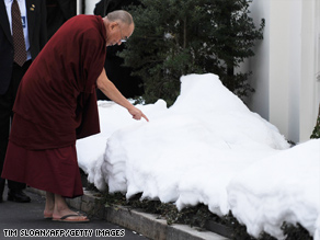 The Dalai Lama draws in the snow with his finger outside the White House after meeting with Pres. Obama earlier today. The meeting drew angry protests from China.