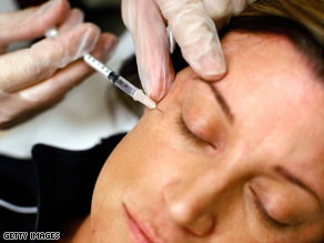 A woman receives a Botox injection. 
