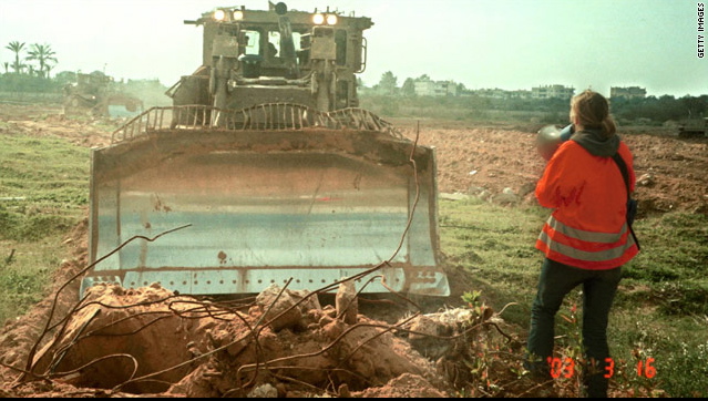 Rachel Corrie tries to prevent a bulldozer razing homes at a Palestinian refugee camp in Rafah, Gaza in a photo dated March 16, 2003, the day she died. She was one of a number of activists at the site from the International Solidarity Movement.