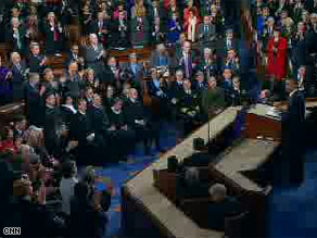 The Supreme Court Justices remain seated while Democrats stand to applaud the President's criticism of the campaign finance ruling at the State of the Union address.