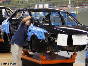 Hyundai employees work on a car on the assembly line at the Montgomery, AL plant