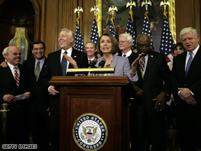 House Speaker Nancy Pelosi, backed by fellow Democrats, speaks at a press conference after the successful passage of health care reform in the House.
