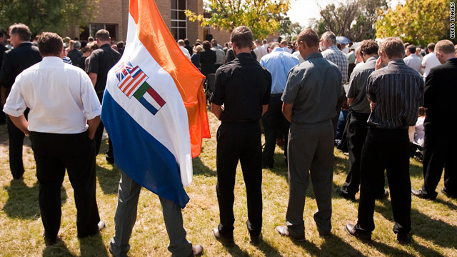 Mourners, one draped in the old South African flag, attend Terreblanche's funeral.