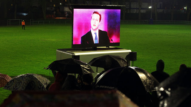 Students in Brimingham brave the rain to watch the third UK election debate between leaders of the main political parties (Getty)