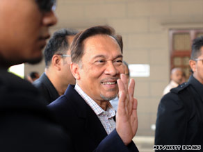 Anwar Ibrahim waves as he walks into court in Kuala Lumpur on May 31.