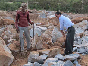 This man shows me how he breaks rocks with an 18-kg hammer in 40C heat for $0.02 per square foot of crushed stone.