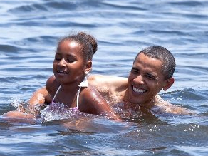 President Barack Obama and daughter, Sasha, on holiday swimming at Alligator Point in Panama City, Florida on August 14, 2010