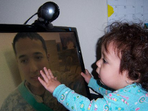 9-month old Alanna 'touching' her father through Skype while he is serving in Iraq. He's spent more time with Alanna over Skype than he has in person.