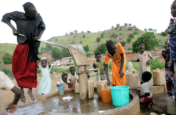 Sudanese residents pump water from a well in their village. Source: AFP/Getty Images