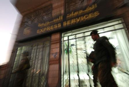 Yemeni security are seen outside a branch of the US package delivery firm UPS in Sanaa (Getty Images)