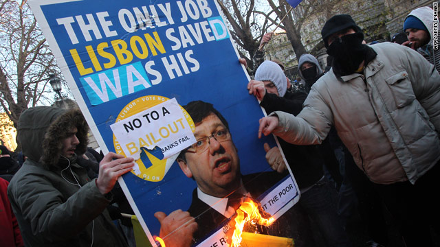 Protesters burn a placard with a picture of Irish PM Brian Cowen in Dublin on November 27.