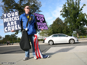 Timothy Phelps, a member of the Westboro Baptist Church from Topeka, Kansas, stands with banners in front of the US Supreme Court on October 6, 2010 in Washington,DC.