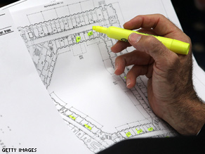 A man highlights vacant offices on a floor plan during an office selection lottery for new House of Representatives members.